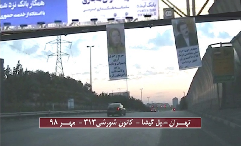 The [MEK] install banners of Massoud and Maryam Rajavi over the Hakim Expressway