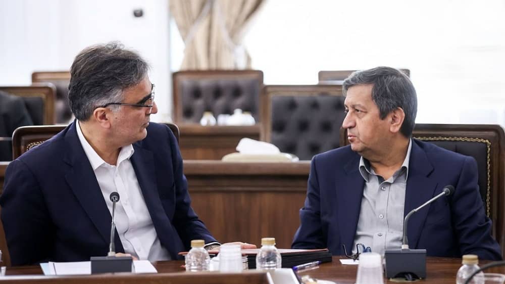 Iranian regime’s Central Bank Governor Mohammad Reza Farzin (left) talking to Economy Minister Abolnaser Hemmati (right)