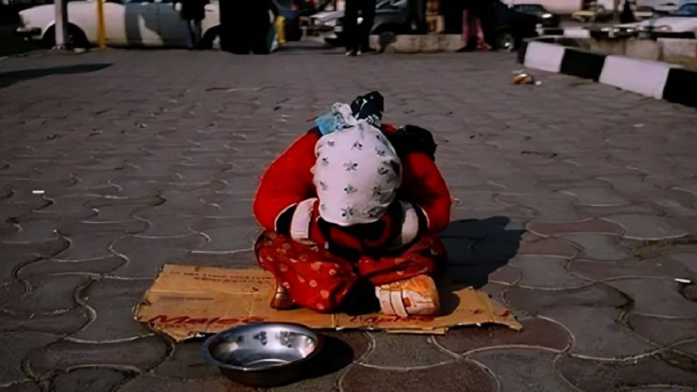 A young girl in Iran begs on the street to help support her family