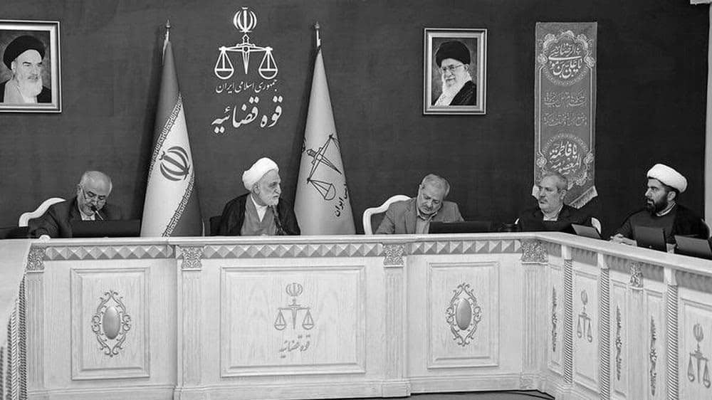 Iranian regime’s Judiciary Chief Gholam Hossein Mohseni Ejei (middle) talks with other judicial officials at a meeting — May 2025